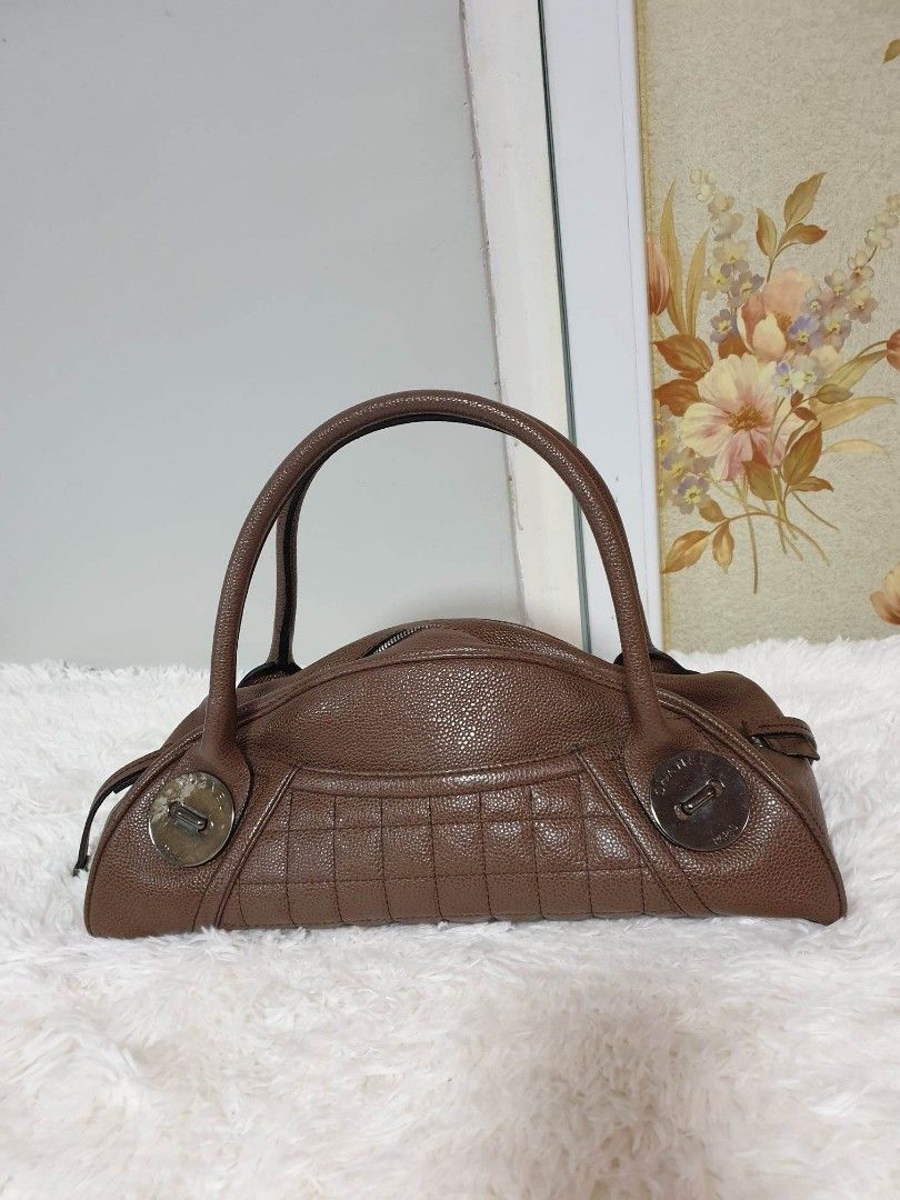 Rare and Vintage Bowling Handbag (Category: Luxury Bags & Wallets) located in Santa Rosa. Submitted by yerbua103 (Listing ID 1219101933, Image 1). Description: 👜This rare and vintage Chanel bag is crafted with a pebbled-like brown leather with a tubular leather double handles and white hardware embedded on the four corners with the brand's signature name. Exterior has open pockets (front and back). Interior is in a cloth lining with the brand's 