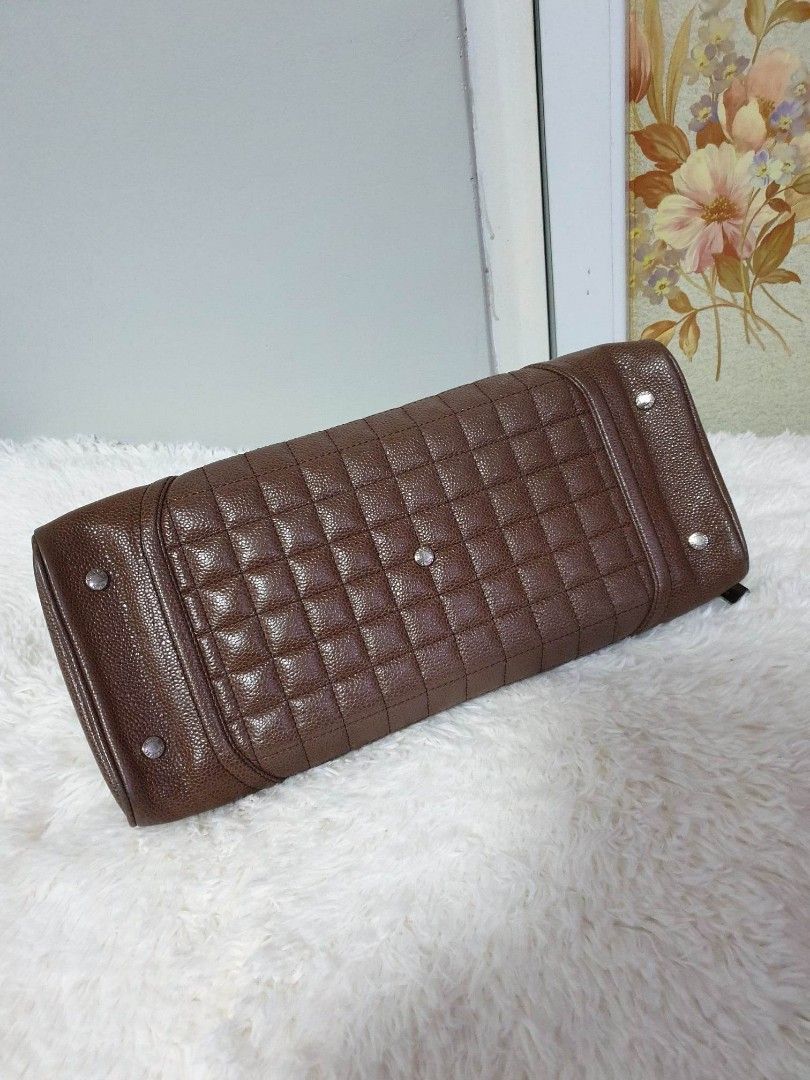 Rare and Vintage Bowling Handbag (Category: Luxury Bags & Wallets) located in Santa Rosa. Submitted by yerbua103 (Listing ID 1219101933, Image 2). Description: 👜This rare and vintage Chanel bag is crafted with a pebbled-like brown leather with a tubular leather double handles and white hardware embedded on the four corners with the brand's signature name. Exterior has open pockets (front and back). Interior is in a cloth lining with the brand's 