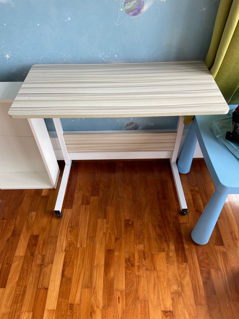Small Study/Work table - height adjustable (Category: Tables & Sets) located in Singapore. Submitted by wminimalist (Listing ID 1219157759, Image 1). Description: Small work/study table for sale. As good as new. New stains or discolouration. Height can be manually adjusted. .
