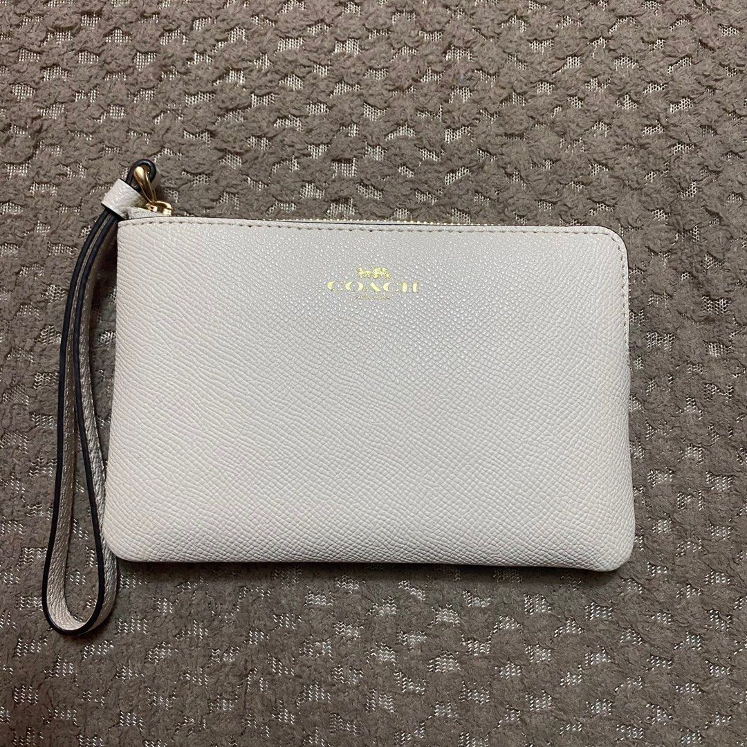 Coach White Wristlet (Category: Luxury Bags & Wallets) located in Quezon City. Submitted by chescita (Listing ID 1219284092, Image 1). Description: has a slight dent but in good condition, never used .