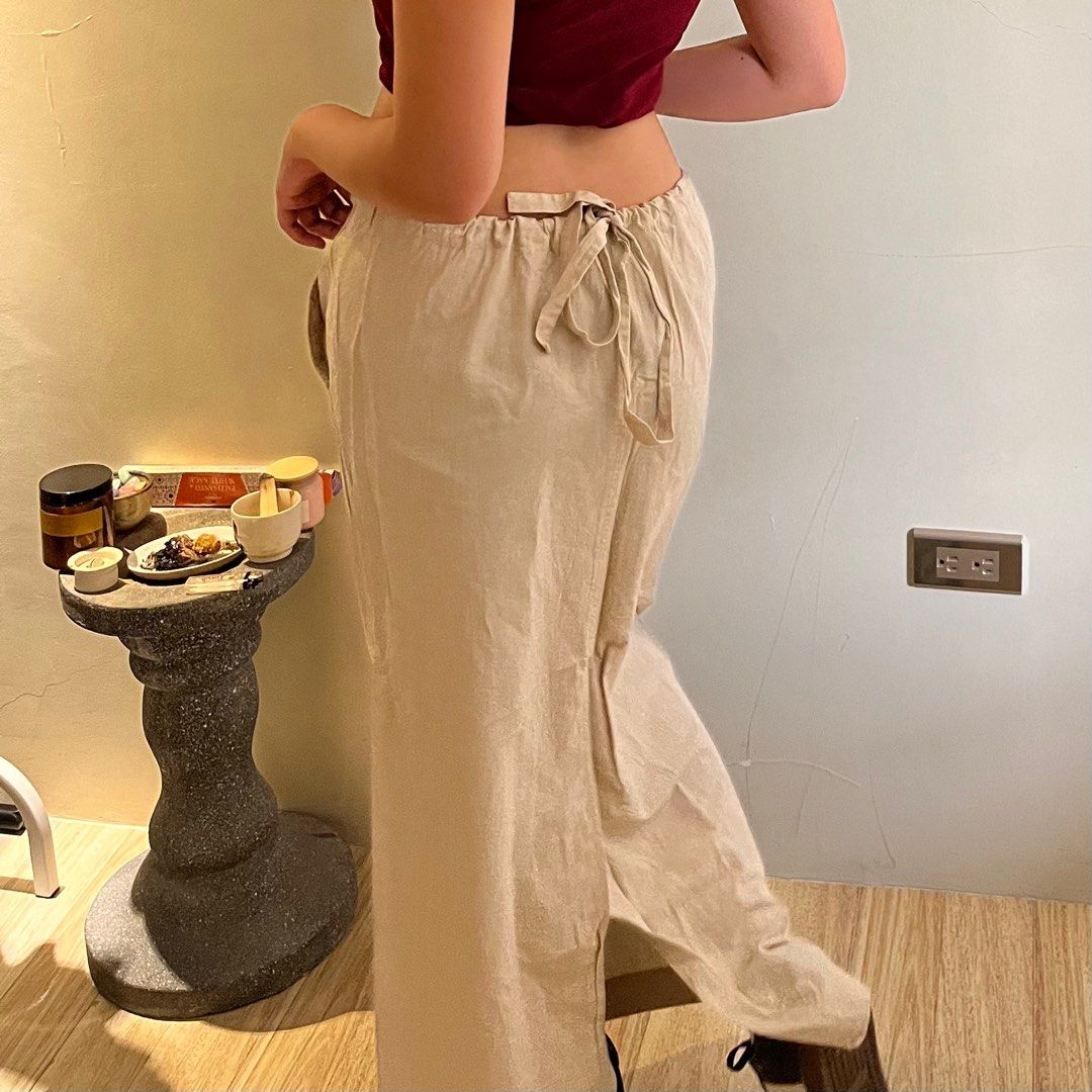 Gorpcore beige long skirt 2000’s (Category: Skirts) located in Calamba. Submitted by fromynes (Listing ID 1219205450, Image 2). Description: 💌 @fromynes on ig small-medium adjustable tie on the back slit shown from behind bagay with adidas sambas 🤍 shopee checkout available!.