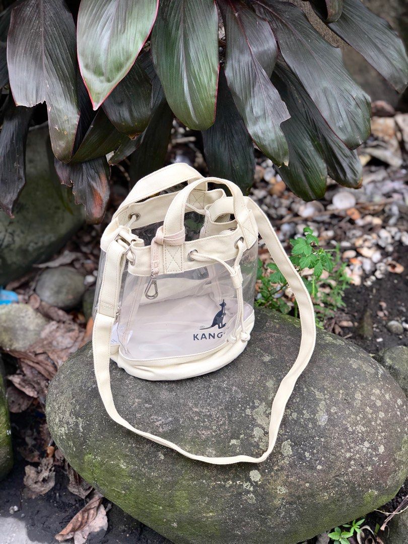 Kangol Transparent Bucket Bag (Category: Cross-body Bags) located in Caloocan City. Submitted by money_maker06 (Listing ID 1219313817, Image 3). Description: •Kangol Transparent Bucket Bag 🌳 •Authentic/Legit 💯 •Size: Medium •It can fit 5-10 items depends on the size of the item 🔌 •Condition: Good •Issue: Stain and Dirt 🖊 •Needs cleaning 🧼 •Price: 589 💰 •Click each picture to appreciate the item 📸 •Dm me if you’re interested. I can give you