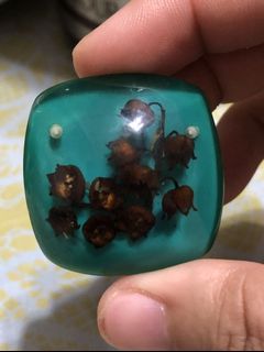 Flower in bluegreen resin brooch