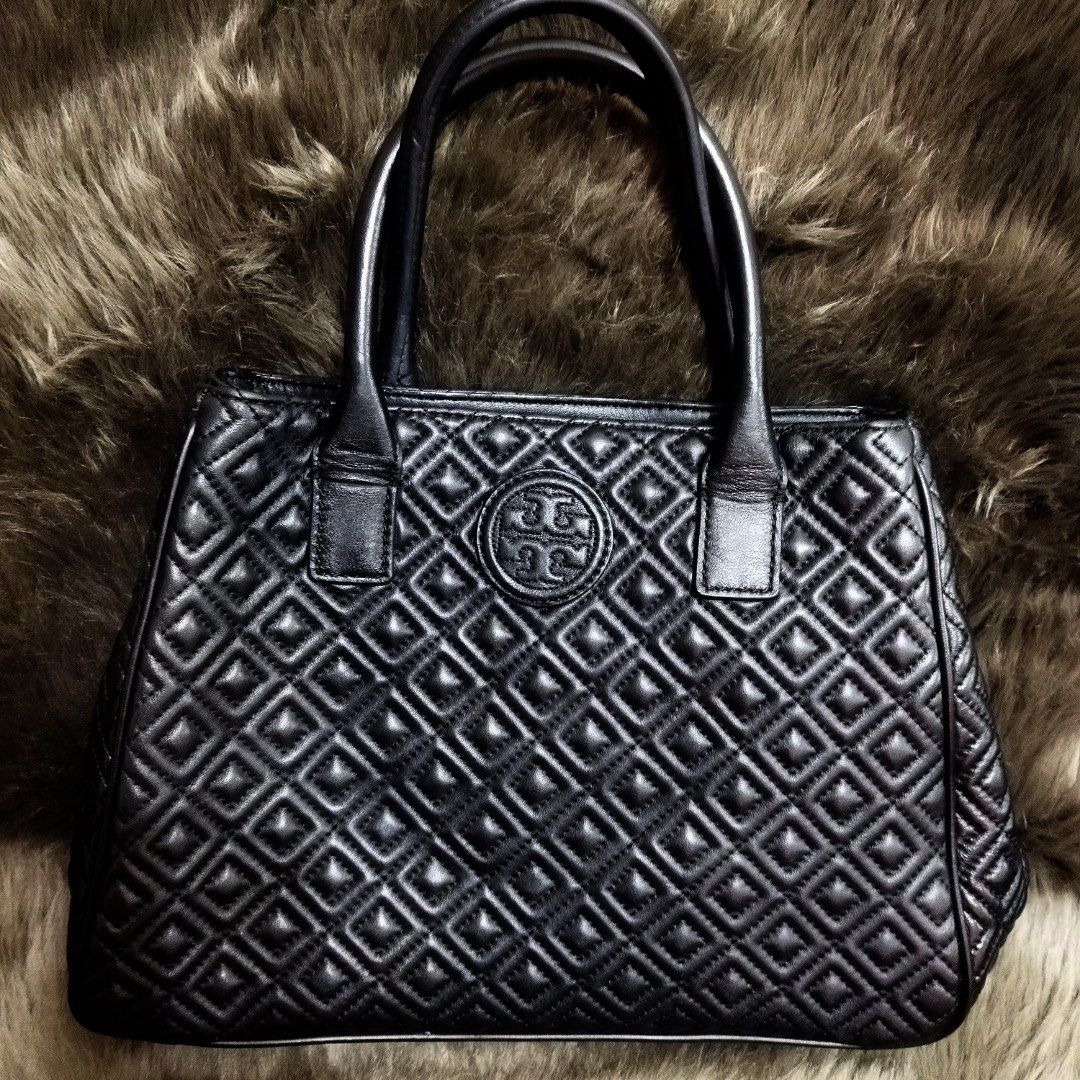 Tory Burch Marion Quilted Tote Bag (Category: Luxury Bags & Wallets) located in Manila. Submitted by shopaholic_gurl (Listing ID 1138397200, Image 1). Description: in excellent like new condition no flaws black leather material worn as hand or shoulder bag clean interior.