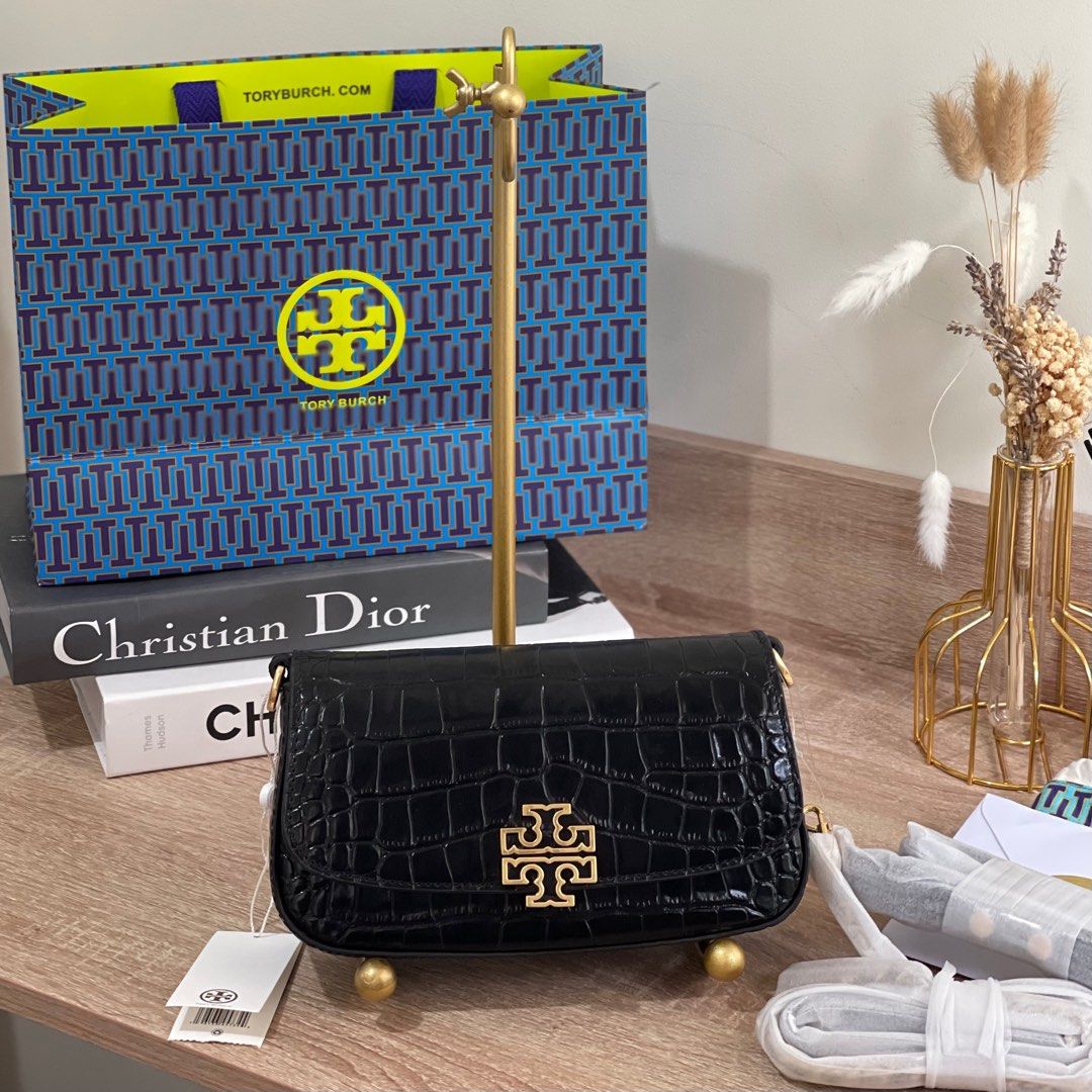 ON HAND: Tory Burch Britten Embossed Convertible Saddle Bag (Category: Cross-body Bags) located in Pasig City. Submitted by lizredclosetph (Listing ID 1225958180, Image 1). Description: ON HAND: Tory Burch Britten Embossed Convertible Saddle Bag Brandnew with complete inclusion.