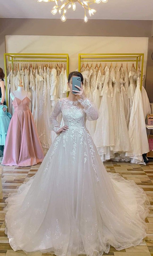 Longtrail Wedding gown with 3D flowers (Category: Evening dresses & gowns) located in Malolos. Submitted by sofideclutters (Listing ID 1226490380, Image 1). Description: Beautiful Longtrail Wedding gown with 3D flowers. Hoarded wedding gown but never used. I bought this because this looks like my mom's wedding church dress. However, never used. Bought in FB for 10K White color Preowned so expect slight sign of usage S-M, tho adjustable back Filip