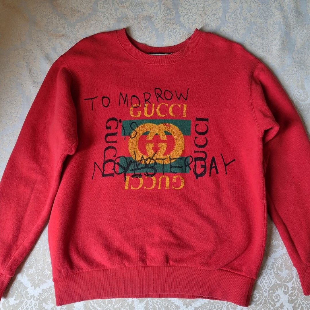 Gucci Red Distressed Sweatshirt / Sweater (Category: Luxury Apparel) located in Manila. Submitted by _moca01 (Listing ID 1226741438, Image 1). Description: GUARANTEED AUTHENTIC 💯 ▫️Red "Tomorrow Is Now Yesterday" Big Logo Printed Distressed Oversized Sweatshirt -USED, in good condition. Ready to use. - Color rate (7.5/10), idk if it's really designed as this since it distressed -Distressed design, OVERSIZED fit in women’s. Model is 5”2 and usual