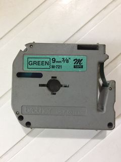 9mmx8m Label Maker Green metallic tape and black text