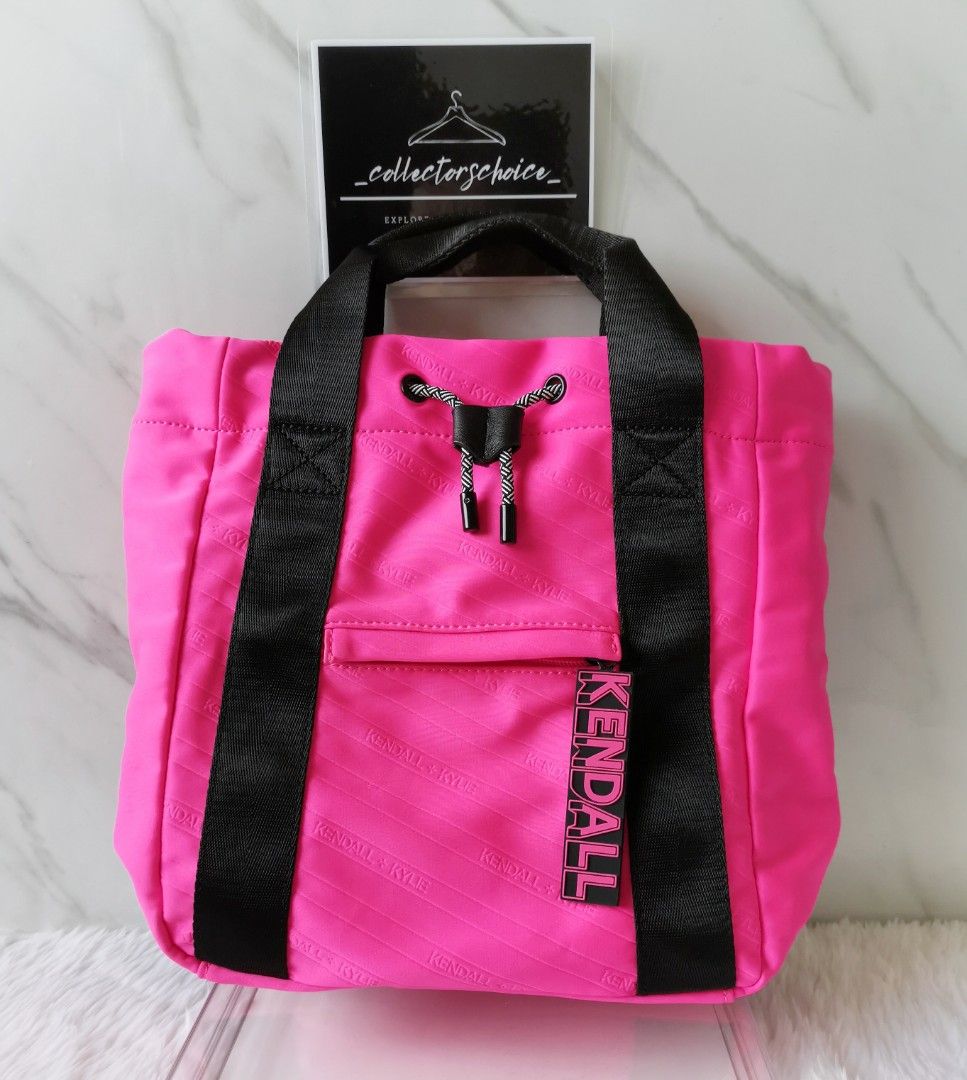 Kendall + Kylie Textured 2 Way Bag (Category: Luxury Bags & Wallets) located in Makati City. Submitted by _collectorschoice_ (Listing ID 1226998040, Image 1). Description: ° Two-way bag (handbag or backpack) ° Closure type: Exterior rope details ° Composition: Neoprene ° Color: Neon pink/black ° Kendall + Kylie rubber puller ° Adjustable strap ° Two handles ° Never used ° MOP: BPI or Unionbank ° Plus shipping fee ° Courier: JRS only (home pick up
