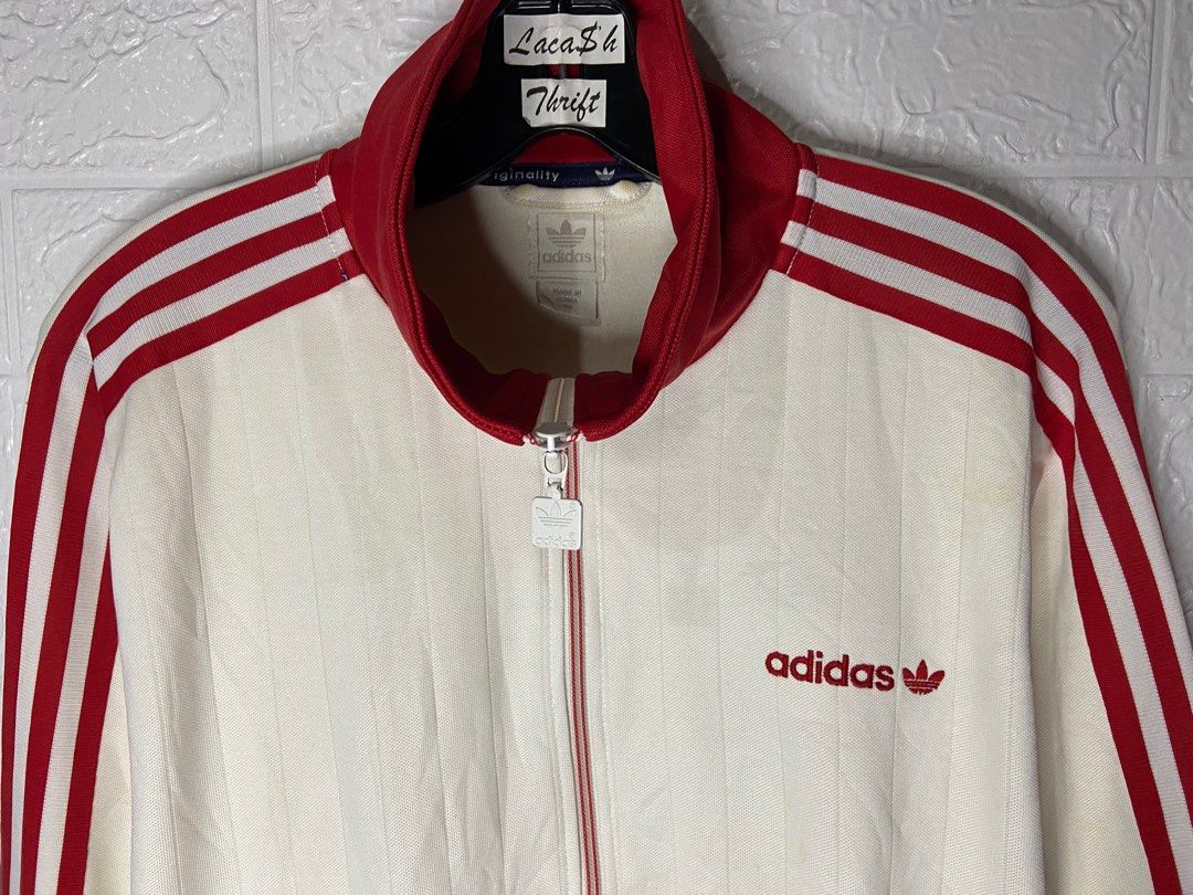 red track jacket with white stripes