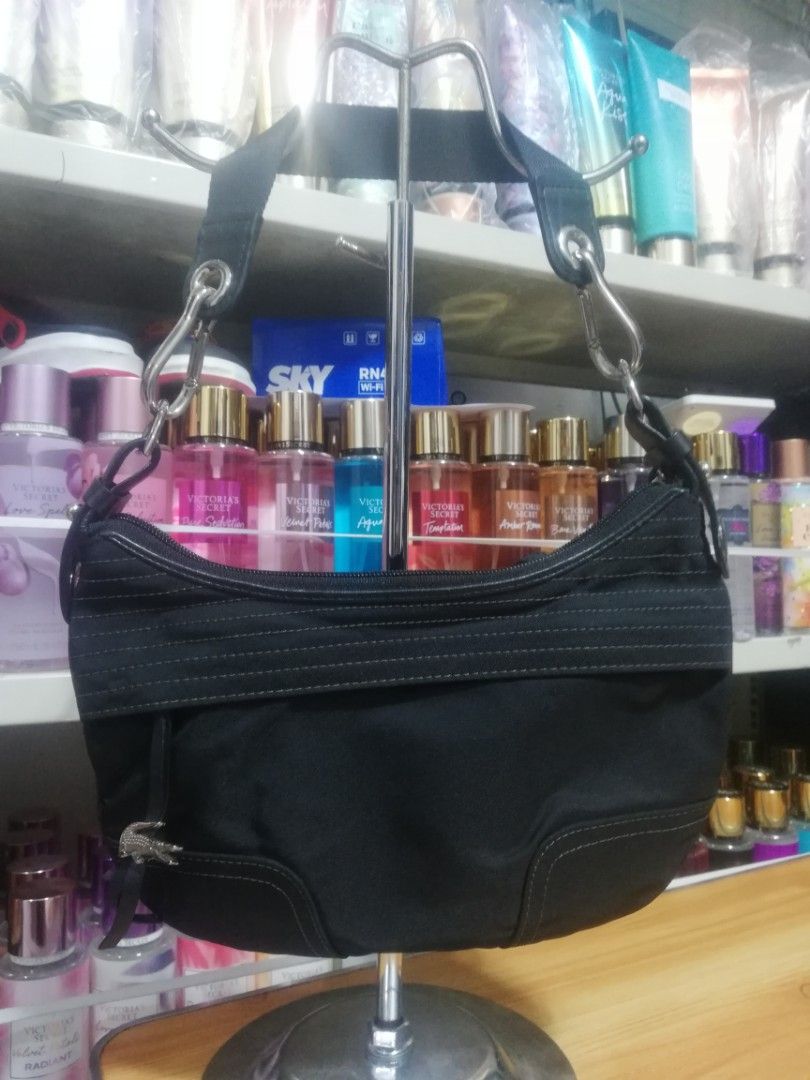 Prelove: Lacoste Shoulder Bag (Category: Shoulder Bags) located in Mandaluyong City. Submitted by earahsco (Listing ID 1224242112, Image 2). Description: Personal prelove. Used twice. Lacoste Small Canvas Shoulder Bag Silver hardware EUC-VGUC to be safe. US Bought.