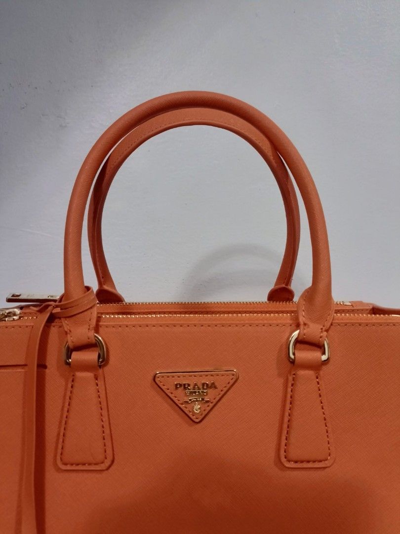 Preloved Prada orange double zipped (Category: Luxury Bags & Wallets) located in Cebu City. Submitted by day.98 (Listing ID 1224147141, Image 3). Description: selected from japan surplus pure saffiano leather genuine leather lampo zipped no flaws with dust bag.