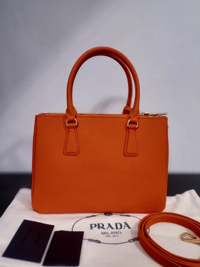 Preloved Prada orange double zipped (Category: Luxury Bags & Wallets) located in Cebu City. Submitted by day.98 (Listing ID 1224147141, Image 2). Description: selected from japan surplus pure saffiano leather genuine leather lampo zipped no flaws with dust bag.