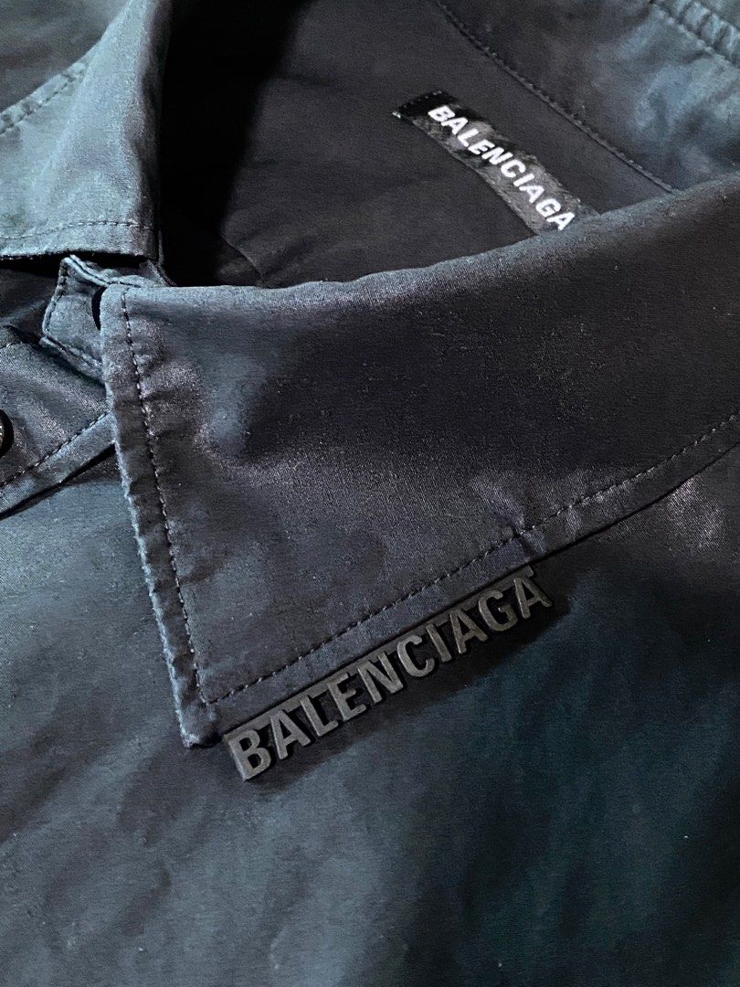 Balenciaga Black Shirt (Category: Luxury Apparel) located in Pasig City. Submitted by capsulecollection (Listing ID 1227598286, Image 2). Description: Balenciaga coated cotton black button down shirt Rubber logo on one side of the collar Boxy fit, wide shoulder .