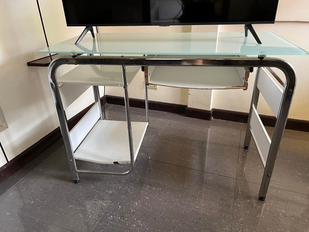 Office Computer Table (Category: Office Furniture & Fixtures) located in Caloocan City. Submitted by rubywednesdays (Listing ID 1227682684, Image 1). Description: FOR SALE: Computer Table / Office Table SIZE: 108cm Width 50cm Depth 76cm Height CONDITION: Used but in working condition; issues on drawer, bars and shelf parts as seen in photos MATERIAL: Mixed - Glass, Metal, Wood PICK UP: Sta. Rosa, Laguna PRICE: Negotiable.