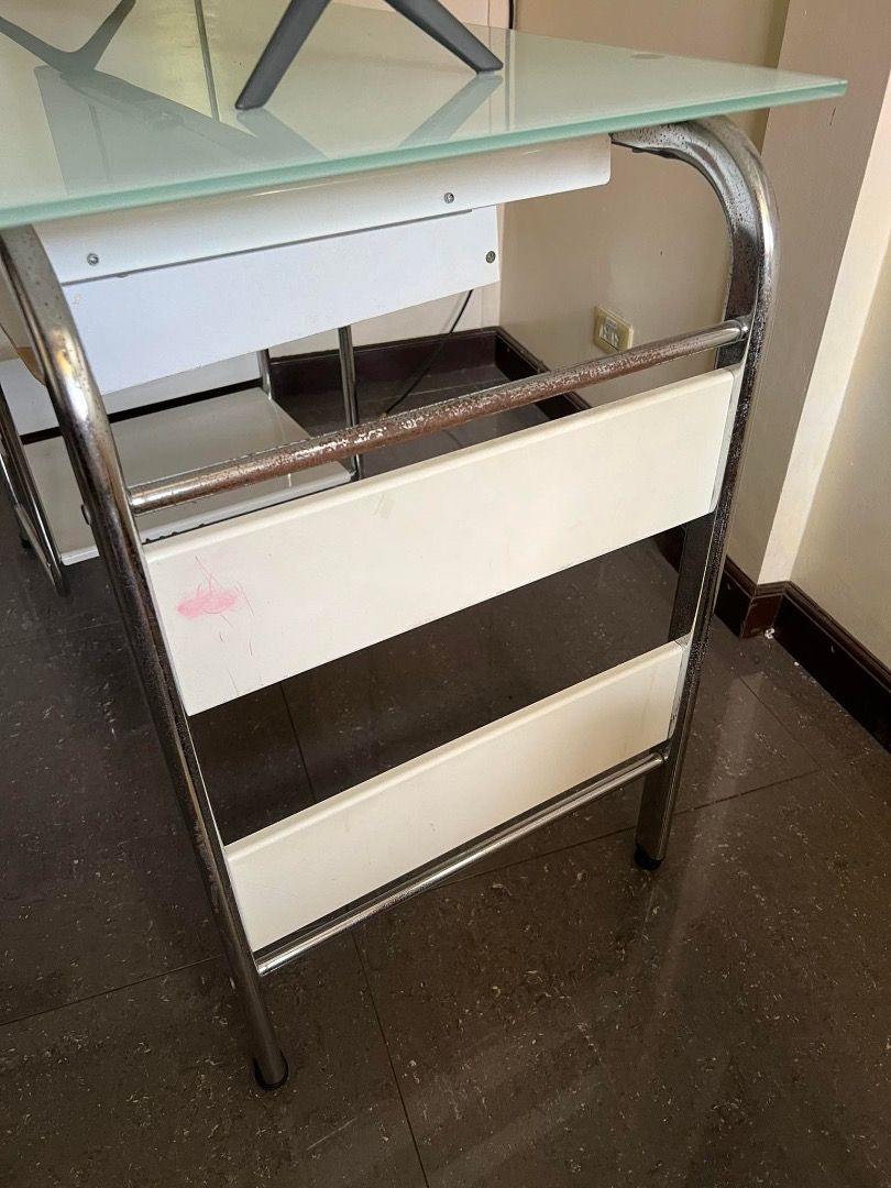 Office Computer Table (Category: Office Furniture & Fixtures) located in Caloocan City. Submitted by rubywednesdays (Listing ID 1227682684, Image 3). Description: FOR SALE: Computer Table / Office Table SIZE: 108cm Width 50cm Depth 76cm Height CONDITION: Used but in working condition; issues on drawer, bars and shelf parts as seen in photos MATERIAL: Mixed - Glass, Metal, Wood PICK UP: Sta. Rosa, Laguna PRICE: Negotiable.
