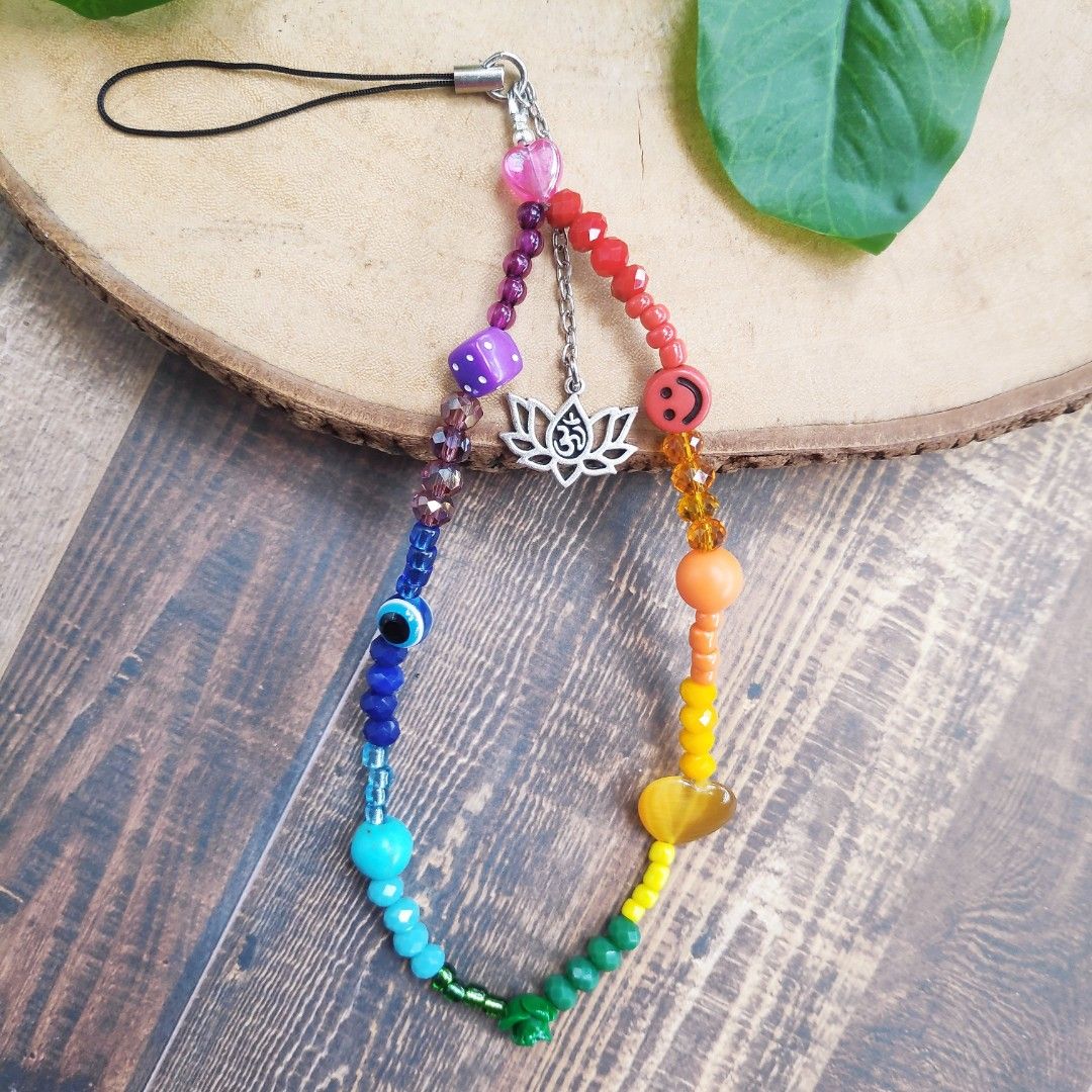 Chakra Phone Charm Strap (Category: Mounts & Holders) located in Manila. Submitted by thestylevixen (Listing ID 1227941539, Image 3). Description: materials: seed beads, cats eye, acrylic beads. length: 9.5cm long sturdy What are chakras? they are energy centers in one's vessel. Each color correspond to which point in one's body that may or may not be out of balanced. 🔴Red is the Root Chakra and located at the bottom. It signifies security, basi