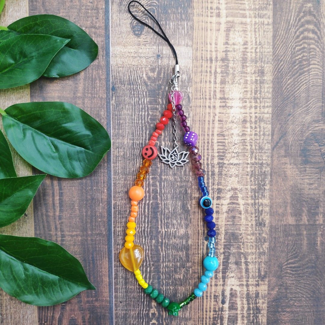 Chakra Phone Charm Strap (Category: Mounts & Holders) located in Manila. Submitted by thestylevixen (Listing ID 1227941539, Image 1). Description: materials: seed beads, cats eye, acrylic beads. length: 9.5cm long sturdy What are chakras? they are energy centers in one's vessel. Each color correspond to which point in one's body that may or may not be out of balanced. 🔴Red is the Root Chakra and located at the bottom. It signifies security, basi
