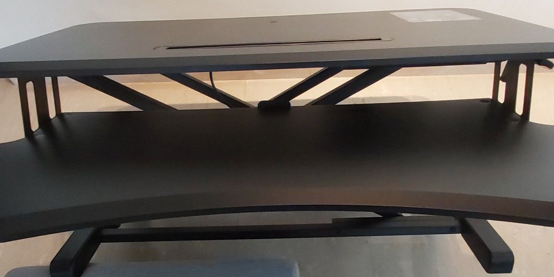 Adjustable desk (Category: Tables & Sets) located in Singapore. Submitted by tanbk001 (Listing ID 1228106928, Image 2). Description: ULTi adjustable desk like new, used for a year only. As my lower back has recovered, selling away. If you buy new, you need to assemble yourself. I have also padded the base with soft pads so that the desk holding it will not be scratched. I can deliver to your house. Weight: 12 k.g. dimension, see link https://caro