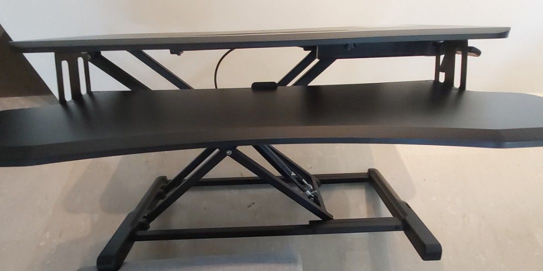Adjustable desk (Category: Tables & Sets) located in Singapore. Submitted by tanbk001 (Listing ID 1228106928, Image 3). Description: ULTi adjustable desk like new, used for a year only. As my lower back has recovered, selling away. If you buy new, you need to assemble yourself. I have also padded the base with soft pads so that the desk holding it will not be scratched. I can deliver to your house. Weight: 12 k.g. dimension, see link https://caro