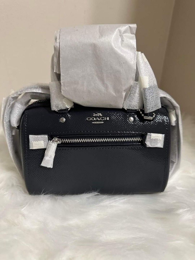 COACH Patent Leather Mini Rowan Crossbody (Category: Luxury Bags & Wallets) located in Dagupan City. Submitted by mrsrraga (Listing ID 1228577967, Image 1). Description: ✅Guaranteed 💯 Authentic from Canada Color: Silver/Midnight Navy MOP: Gcash only Product Details: - Patent crossgrain leather and smooth leather - Two credit card slots - Zip-top closure, fabric lining - Handles with 2 3/4" drop - Outside zip pocket - Detachable strap with 23 1/2