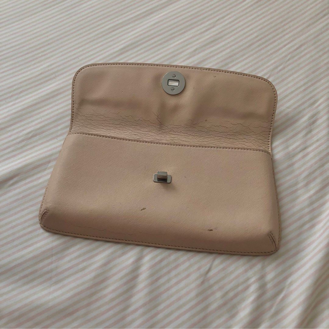Authentic Tory Burch Clutch Nude Beige Leather Silver Logo Hardware (Category: Luxury Bags & Wallets) located in Quezon City. Submitted by selling.my.closet (Listing ID 1228287762, Image 2). Description: Paint coming off due to storage and heat, but can be repaired.