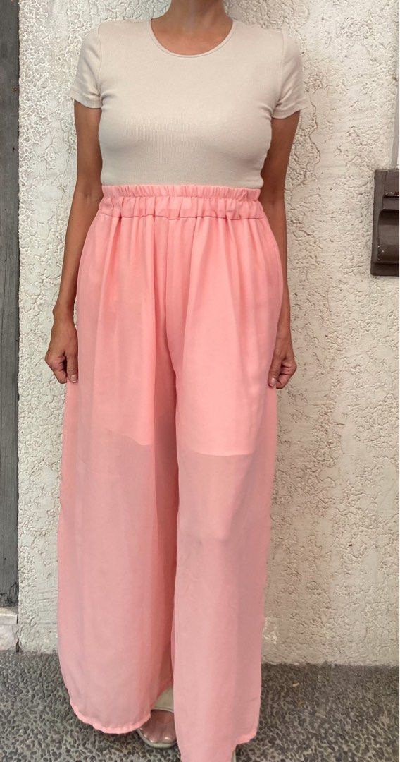 Pink Palazzo Pants (Category: Other Bottoms) located in Quezon City. Submitted by mommake (Listing ID 1229413164, Image 1). Description: - Cutest salmon pink - Chiffon, with lining up to just above the knee - Waist/hips (laid flat): 12 inches, comfortably stretchable until 14 inches, 36 inches in length - Shipping c/of buyer, item can be shipped from QC, Ortigas, or Makati, can also ship via Flash/Gogo Express, no Shopee checkout Model’s dimensio