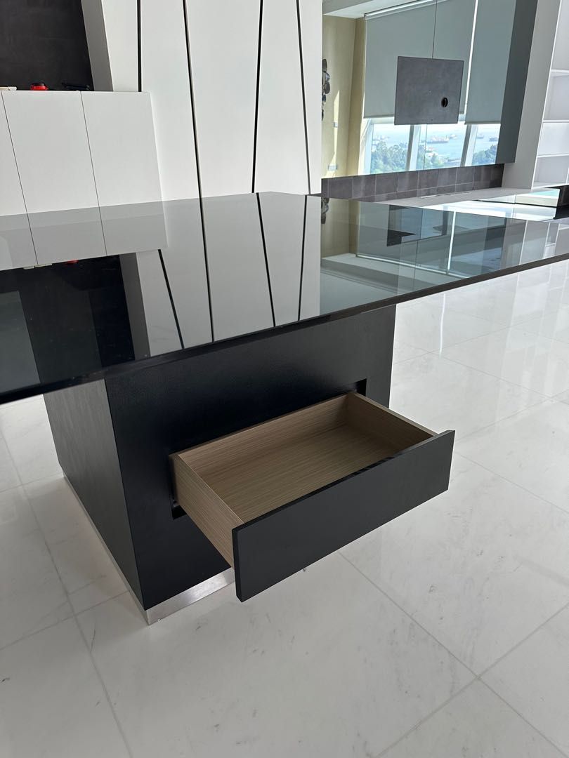 Dining Table (Category: Tables & Sets) located in Singapore. Submitted by laserman8888 (Listing ID 1224976104, Image 3). Description: A custom-made dining table with tempered glass top, tinted and attached to a wooden base with 2 drawers on opposing sides. Dimensions: 140 x 140 x H75 cm Base 70 x 70cm Excellent condition Good for 9-12 people Please arrange for your own transportation. .