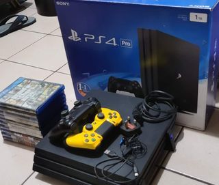 FOR SALE PS4 PRO with 10 Physical Games and 2 controllers power chord and USB charging cable with Horizontal Stand