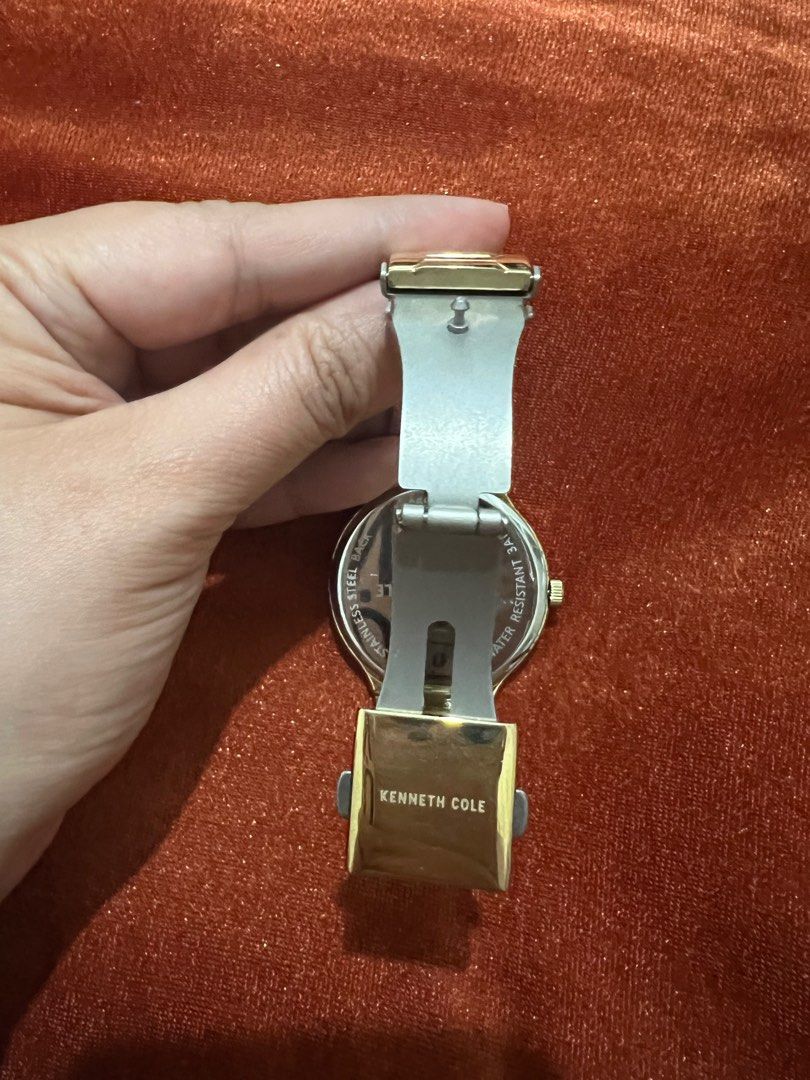 Kenneth Cole Unisex Gold Watch (Category: Luxury Watches) located in Pasig City. Submitted by kittychum (Listing ID 1229568123, Image 3). Description: Kenneth Cole Unisex Watch Color: Gold Wrist Size: 7 inch / 18cm Flaws: Little Brown Stain but barely noticeable.