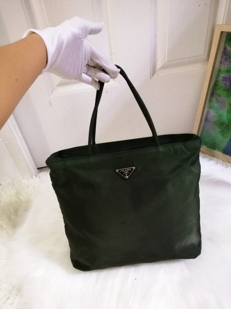 💯Authentic Prada Nylon Tote bag in Green (Category: Luxury Bags & Wallets) located in Malolos. Submitted by sofideclutters (Listing ID 1231225174, Image 2). Description: MOVEOUT SALE❗ SAGAD NA PO SA 7,500❗❗TAKE IT OR LEAVE IT❗ Guaranteed Original/Authentic Prada Nylon Tote bag in Green Vintage model so bulldog underzip Malinis at no foul smell po Money back guaranteed if proven fake Rank A pa po, may tahi ko lang, see last photo. Have it sewned 