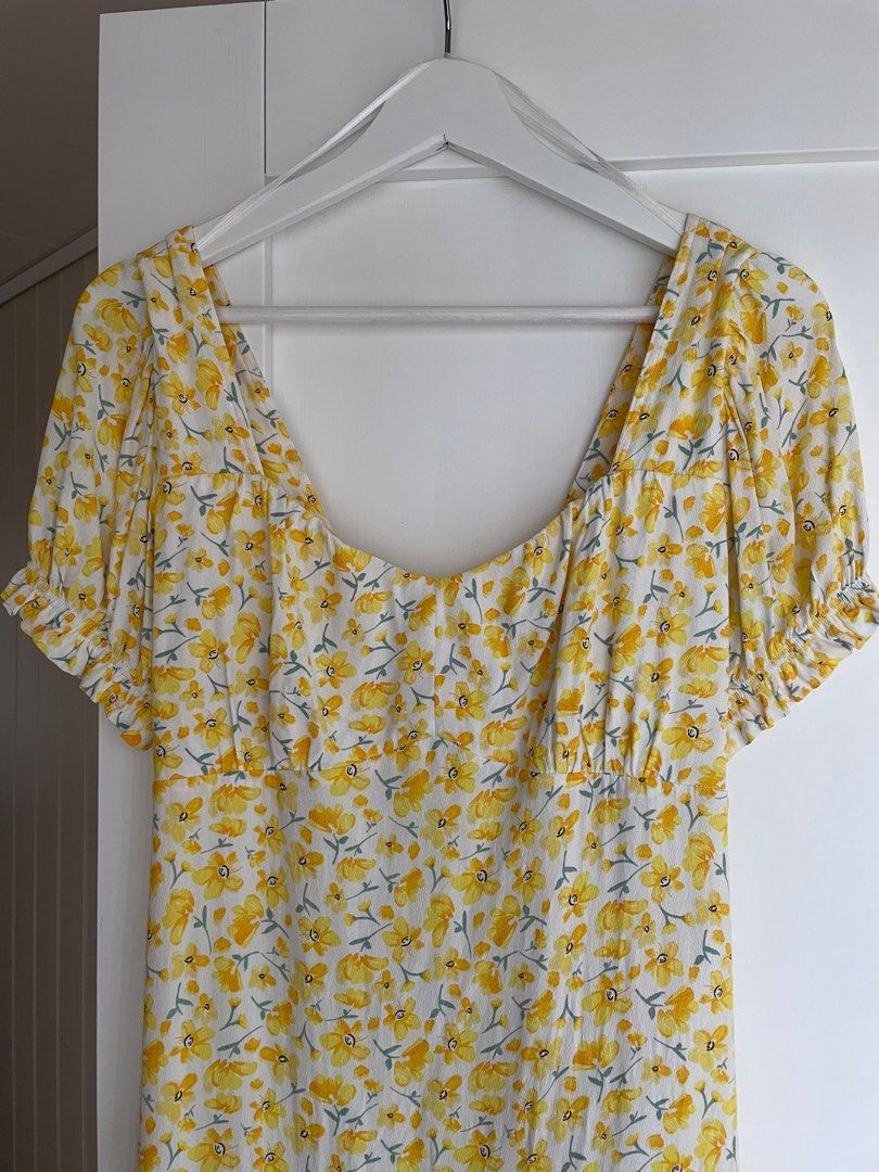 Yellow floral dress (Category: Dresses) located in Pasig City. Submitted by eiemnl (Listing ID 1231398088, Image 3). Description: No when worn photos Best fit for size XS, waist 25-26 has low neckline .