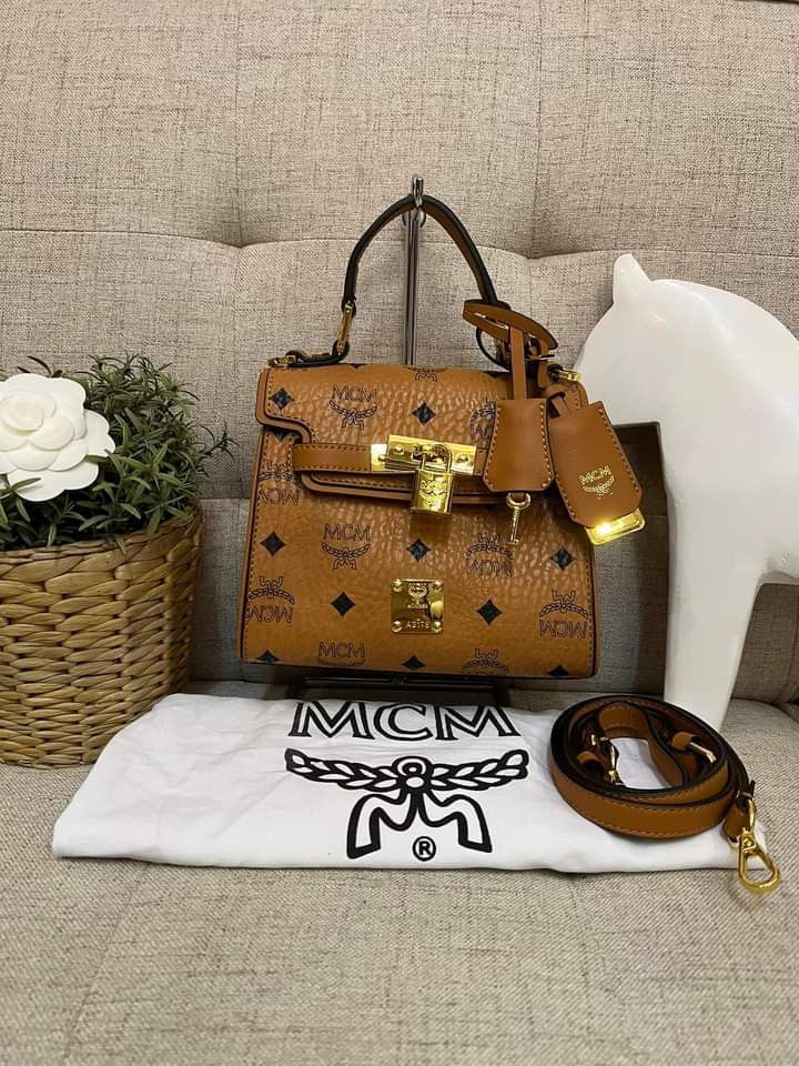 MCM Mini Heritage Satchel Bag (Category: Luxury Bags & Wallets) located in Manila. Submitted by bagislifeshop (Listing ID 1231648648, Image 2). Description: Ohhh My, Kelly!!! 💛💛💛 On Hand in PH 🇵🇭 100% Authentic MCM Mini Heritage Satchel Bag Condition: 9/10 Like New Comes with Dustbag and Strap.