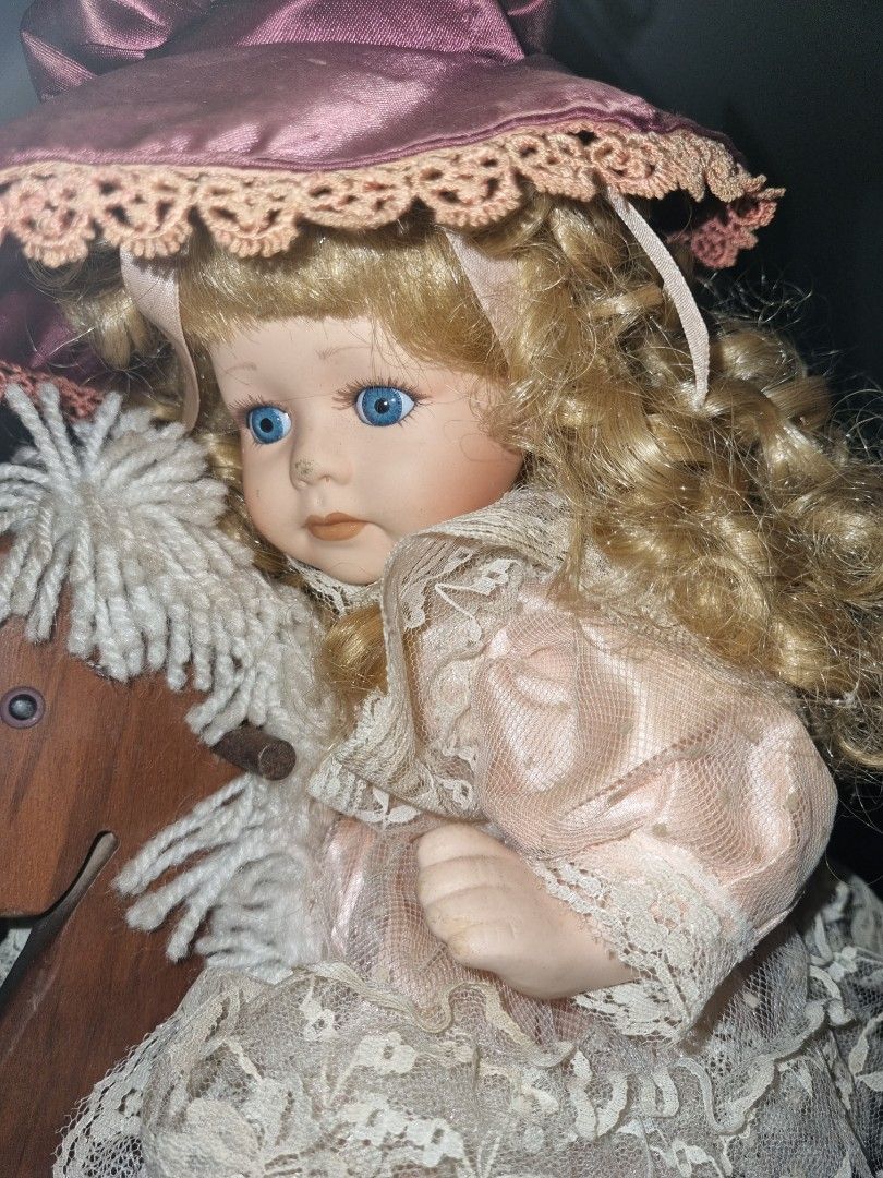Porcelain doll discount on rocking horse