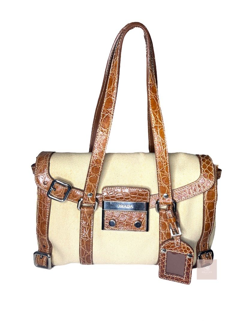 Prada shoulder bag canvass and leather (Category: Luxury Bags & Wallets) located in Manila. Submitted by Qratedph.pieces (Listing ID 1232112257, Image 1). Description: Prad.a shoulder bag canvass and leather (like Herbag) Rank AB, small stain at the back, split leather No inclusion Php 8,500 *color may vary due to lighting Disclaimer: Qratedph.pieces is not associated or affiliated with the brands featured. All copyrights and trademarks reserved 