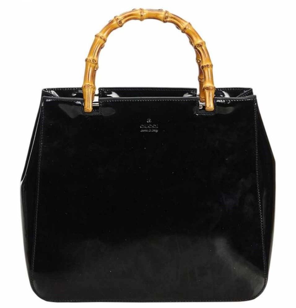 Authentic Gucci patent leather bamboo handle bag (Category: Luxury Bags & Wallets) located in Donsol. Submitted by saksthriftavenuebyluckymaria8 (Listing ID 1193035163, Image 1). Description: 10in length x 9in height x 3in width Handle drop 3 in Well used condition Side part with deformation 1 zipped pocket Open tote bag Made in Italy With serial code .
