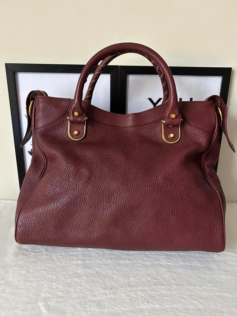 Balenciaga Metallic Edge Velo (Category: Luxury Bags & Wallets) located in Manila. Submitted by bagislifeshop (Listing ID 1232485620, Image 2). Description: ▪️Balenciaga Metallic Edge Velo▪️ ☑️Available in Manila ✅Condition: 8.5/10 ✅Colour: Maroon in Gold hardware ✅Material: Goatskin leather ✅Inclusions: Mirror and long strap .