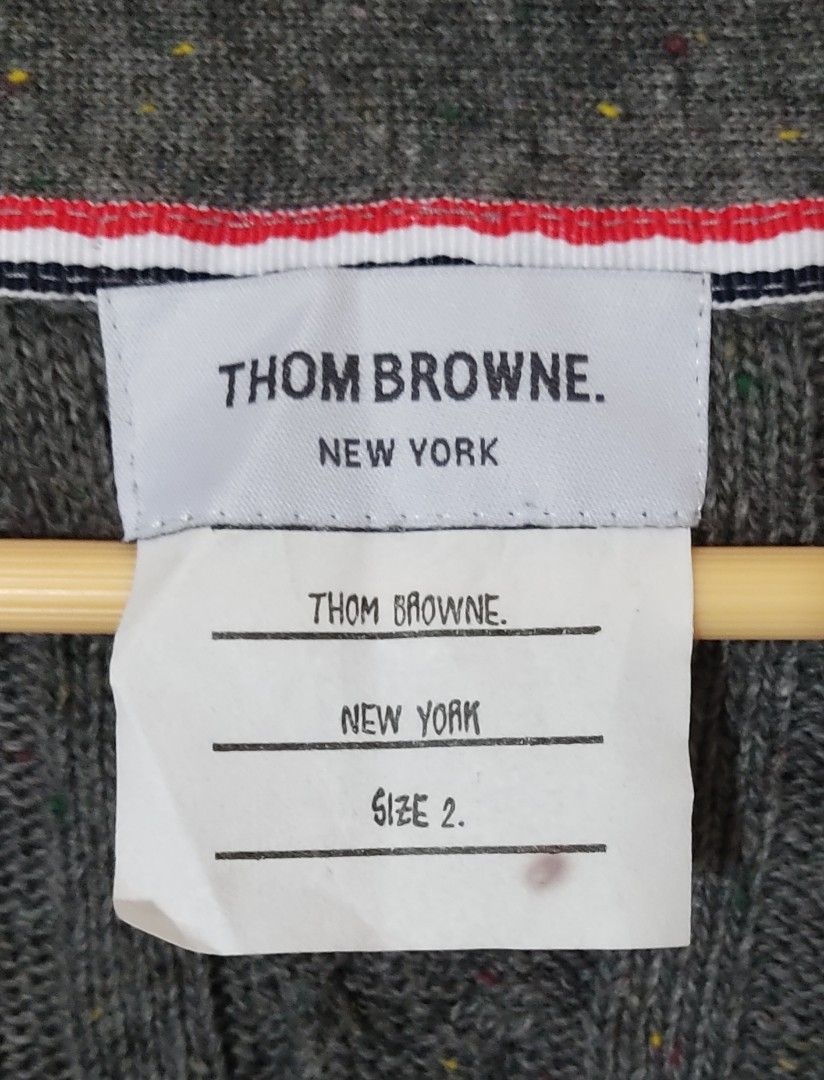 Thom Browne cardigan (Category: Luxury Apparel) located in Las Pinas. Submitted by 05.11minimalist (Listing ID 1232420367, Image 3). Description: Thom Browne v-neck cardigan. Grey. Size 2 on tag. Made in Japan. Dimensions: 22"W x 27"L. Sleeves: 22". Front button closures. Tight hem and wrist cuffs. No fluffings. No runs, rips or holes. In very good condition..