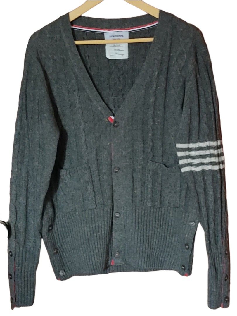 Thom Browne cardigan (Category: Luxury Apparel) located in Las Pinas. Submitted by 05.11minimalist (Listing ID 1232420367, Image 1). Description: Thom Browne v-neck cardigan. Grey. Size 2 on tag. Made in Japan. Dimensions: 22"W x 27"L. Sleeves: 22". Front button closures. Tight hem and wrist cuffs. No fluffings. No runs, rips or holes. In very good condition..