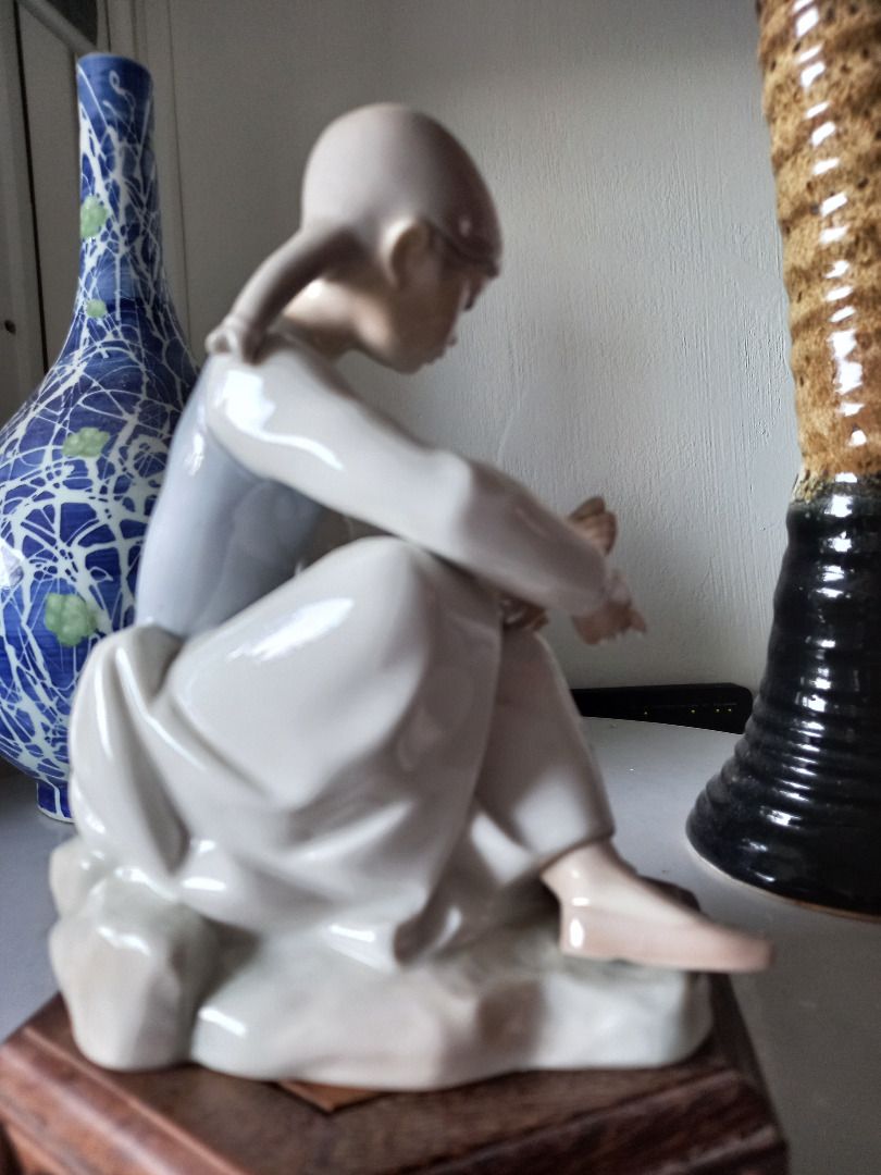 Lladro of Spain, figurine collection of a Yong Girl cleaning tendering