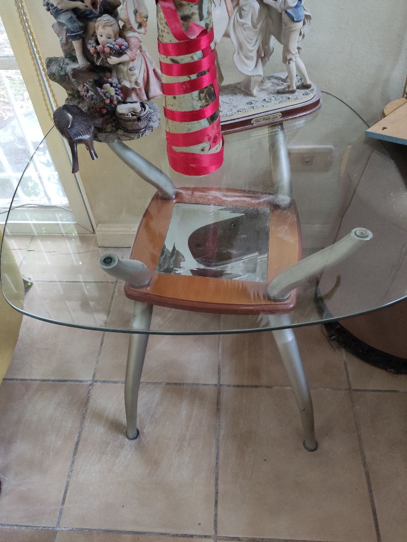 Modern Glass Side/ Top End Table with Steel Base (Category: Tables & Sets) located in Quezon City. Submitted by furnitures53134 (Listing ID 1229809525, Image 1). Description: This modern side/ end table is the perfect addition to any home. The table features a sleek design with a clear glass top and a polished chrome base. The glass top is in excellent condition, with no cracks or scratches. The table is sturdy and well-made, ensuring that it wil