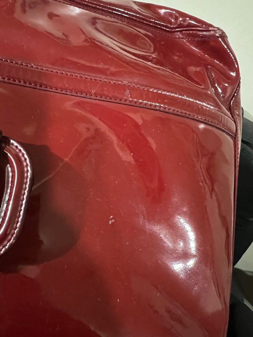 💯Ferragamo Patent bag (Category: Luxury Bags & Wallets) located in Quezon City. Submitted by KK_declutterluxx (Listing ID 1232930566, Image 2). Description: Authentic Salvatorre Ferragamo patent dark red bag - preloved so please expect signs of usage - has some rubs at the bottom but tolerable - ipad regular size is not included, for size comparison only Very elegant bag ❌NO LOW BALLERS❌ Sf c/o buyer QC location.