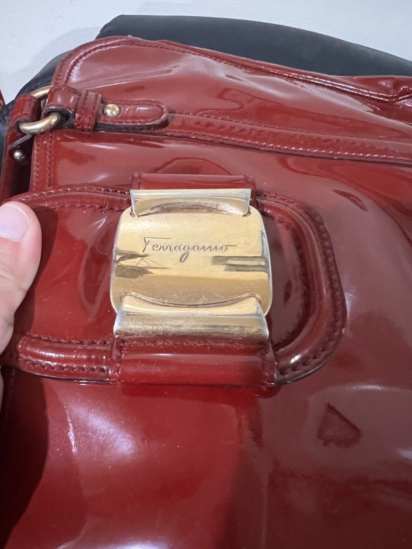 💯Ferragamo Patent bag (Category: Luxury Bags & Wallets) located in Quezon City. Submitted by KK_declutterluxx (Listing ID 1232930566, Image 3). Description: Authentic Salvatorre Ferragamo patent dark red bag - preloved so please expect signs of usage - has some rubs at the bottom but tolerable - ipad regular size is not included, for size comparison only Very elegant bag ❌NO LOW BALLERS❌ Sf c/o buyer QC location.