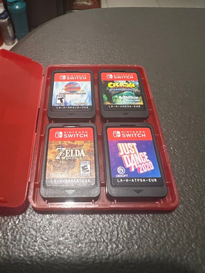 Nintendo Switch V2 (non-LED) (Category: Nintendo) located in Makati City. Submitted by six94 (Listing ID 1233153730, Image 2). Description: Barely used Nintendo Switch V2 (gray) with accessories and games Dock and original HDMI cable unavailable (left them at the house of someone I'm not getting in touch with anymore) INCLUSIONS: + Original charger + Original joy-con charging grip + Hardshell case for the console + Well-placed tempered glass scre