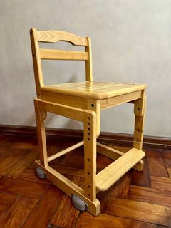 Wooden adjustable chair fits children through adults