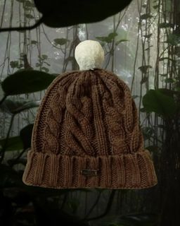 brown cable knit beanie with white pom poms