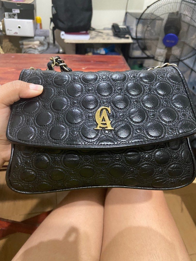 Christian Aujard Chain Sling Bag (Category: Luxury Bags & Wallets) located in Mandaluyong City. Submitted by kacianna (Listing ID 1233327340, Image 2). Description: Genuine Leather, super nice quality Still in good condition but hardware on sling a little faded, 6/10.