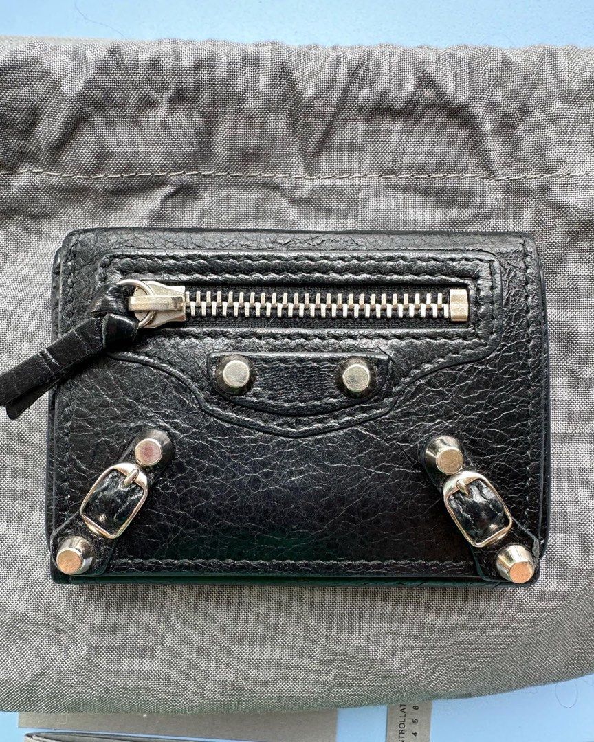 Authentic Balenciaga Compact Wallet (Category: Luxury Bags & Wallets) located in Pasig City. Submitted by kitsch_closet (Listing ID 1233617174, Image 2). Description: Authentic Balenciaga Compact Wallet *Black distressed Leather, Silver hardware. *hard to find style *Inclusions: original dustbag, box, cards *Rank: AB- B *With signs of usage, hairline scratches, ✨️Php 12k only.