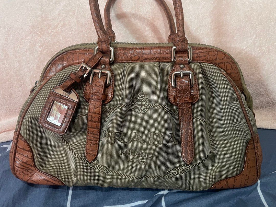 PRADA jacquard doctor’s bag (Category: Luxury Bags & Wallets) located in San Pablo. Submitted by prelovedbymistyblue (Listing ID 1233733886, Image 3). Description: Super nice prada doctors bag. The bag has discoloration on the canvass. It is very spacious. It is also made of croc skin on the lining . Still very nice. The hardwares has prada in it. Measures 14 x 8.5 x 5 inches. Selling low for 3000, down to 2700, 2300, then 2000.