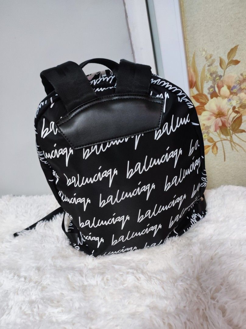 🎒 Blk and White BP (Category: Luxury Bags & Wallets) located in Santa Rosa. Submitted by yerbua103 (Listing ID 1234189360, Image 2). Description: 🎒This functional balenciaga backpack features white print front and back with adjustable black straps and a small top handle. zip closure, print on big font at the top. the interior and exterior is clean. the bag is in mint condition, 9.5/10. 🎒 authenticity of the bag is not guaranteed. 🎒manage your